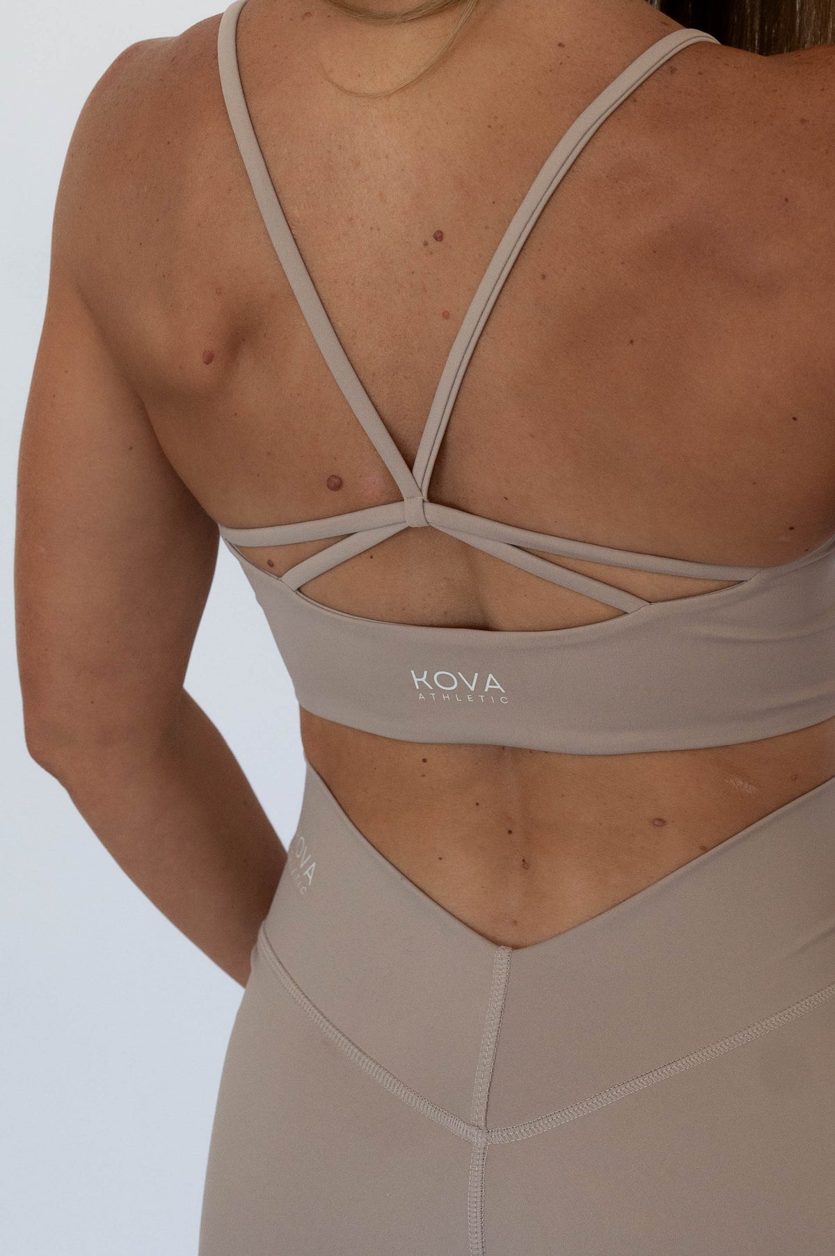 Woman wearing KOVA Sculpt Sports Bra in Stone